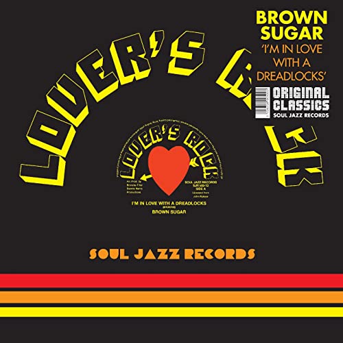 Black vinyl record label with yellow text and a red heart design.