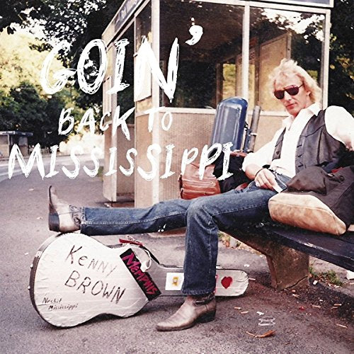 "Album cover with man sitting on a bench with a guitar case."
