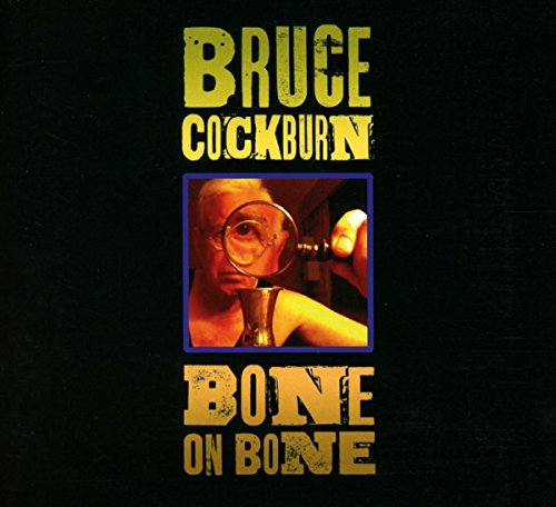 Bruce Cockburn's "Bone On Bone" album cover: black background, yellow text, and a man with a magnifying glass.