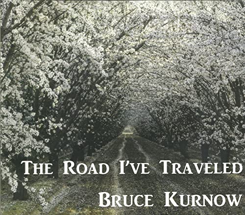 CD cover: dirt road receding into a tunnel of blossoming trees.