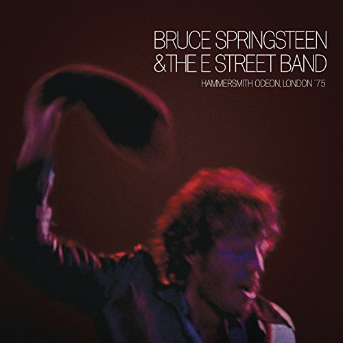 Bruce Springsteen performing on stage with text overlay in a dark, moody concert setting.