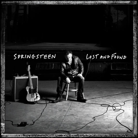 Black and white album cover featuring Bruce Springsteen sitting with a guitar.