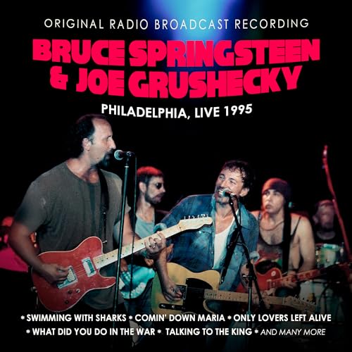 Bruce Springsteen and Joe Grushecky performing live on stage with guitars in 1995.