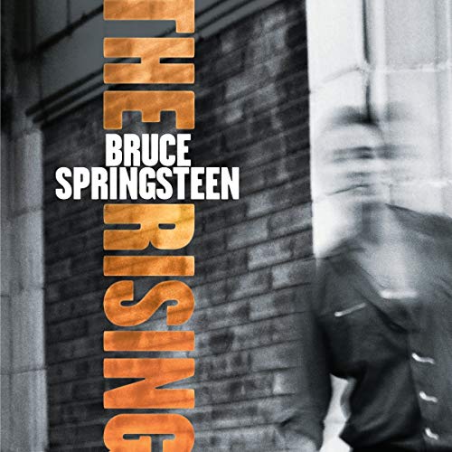 Album cover featuring a blurred figure of Bruce Springsteen standing against a brick wall.