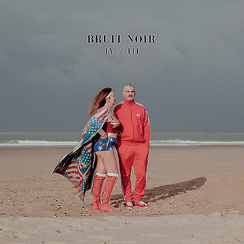 CD cover: couple on beach, one in superhero costume, grey sky.