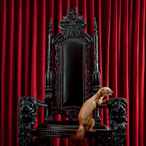 Taxidermied marten standing on ornate, dark throne against red curtains.
