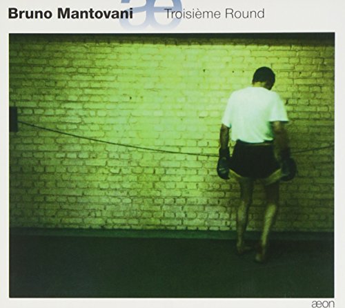 CD cover: boxer with back to viewer, green and yellow tones.
