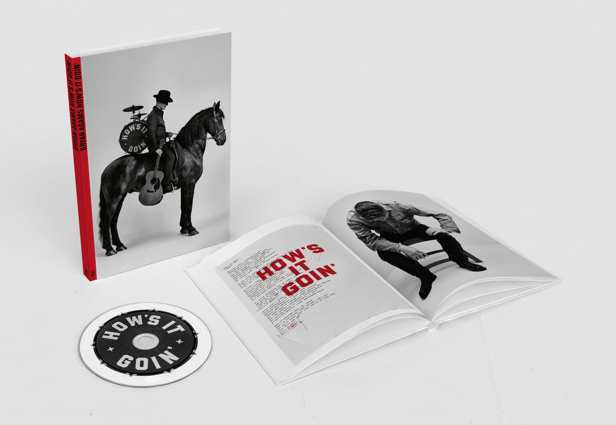 Bryan Adams “Hows It Goin” deluxe book with CD, open to a photo.