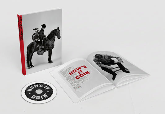Bryan Adams “Hows It Goin” deluxe book with CD, open to a photo.