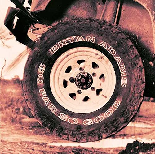 Close-up of a vehicle tire with Bryan Adams So Far So Good written on it.