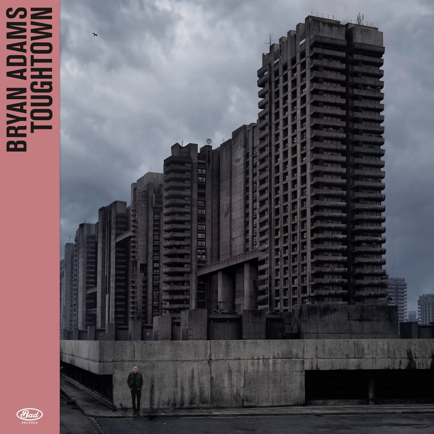 Bryan Adams' "Tough Town" CD cover: Brutalist buildings and a lone figure.