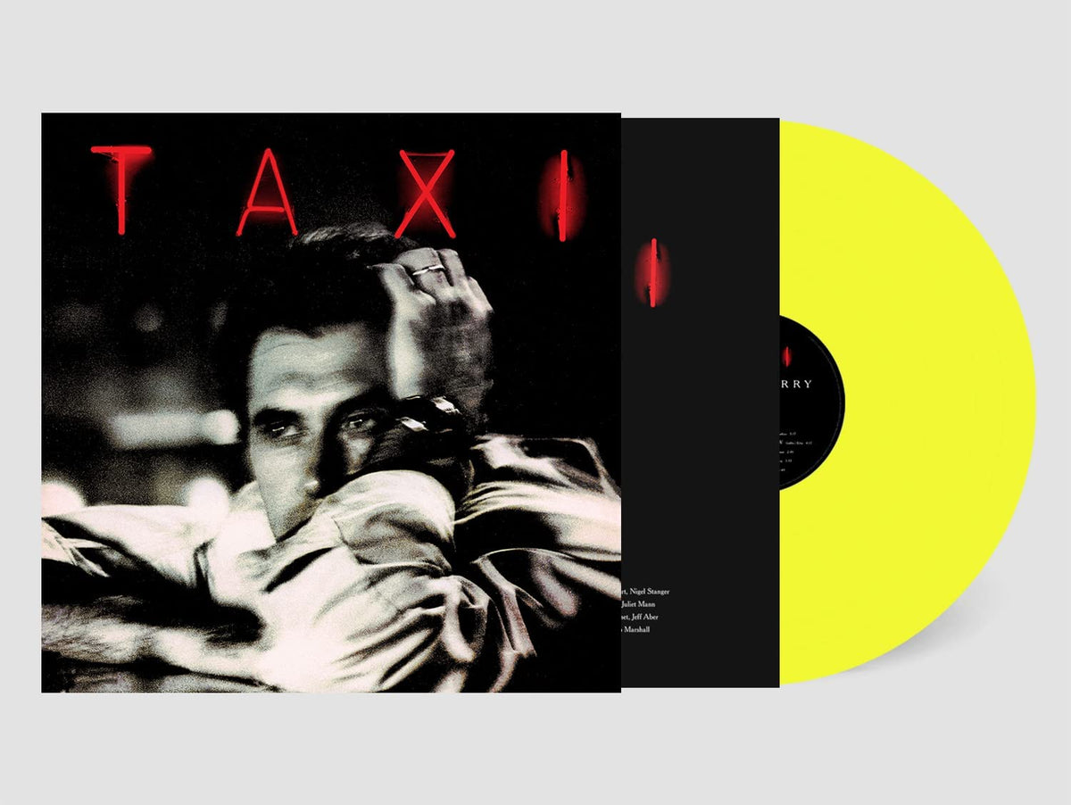 Yellow vinyl record with black sleeve featuring a man in a white shirt.