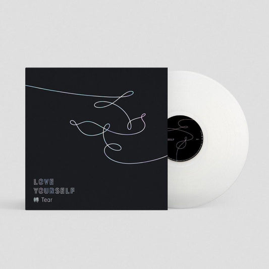 Black album cover with white line art and a white vinyl record beside it.