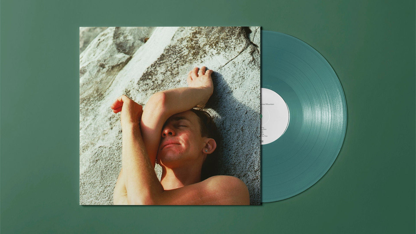 Vinyl record with album cover showing a person lying on rocks.