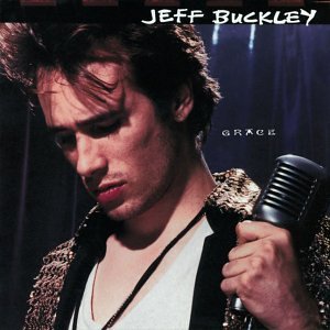 Jeff Buckley looking down while holding a microphone on the Grace album cover.