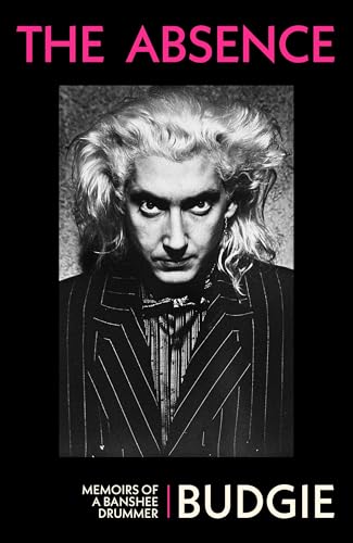 Black and white portrait of a man with striking hair and intense gaze.
