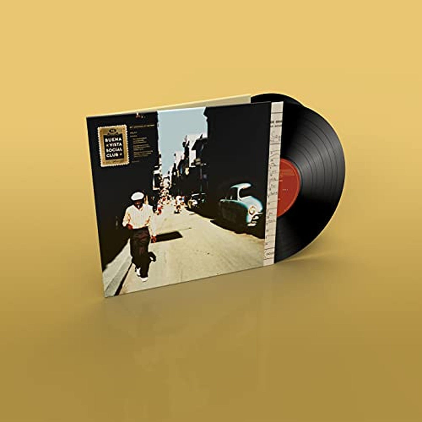 Vinyl record with cover showing a street scene and classic car.