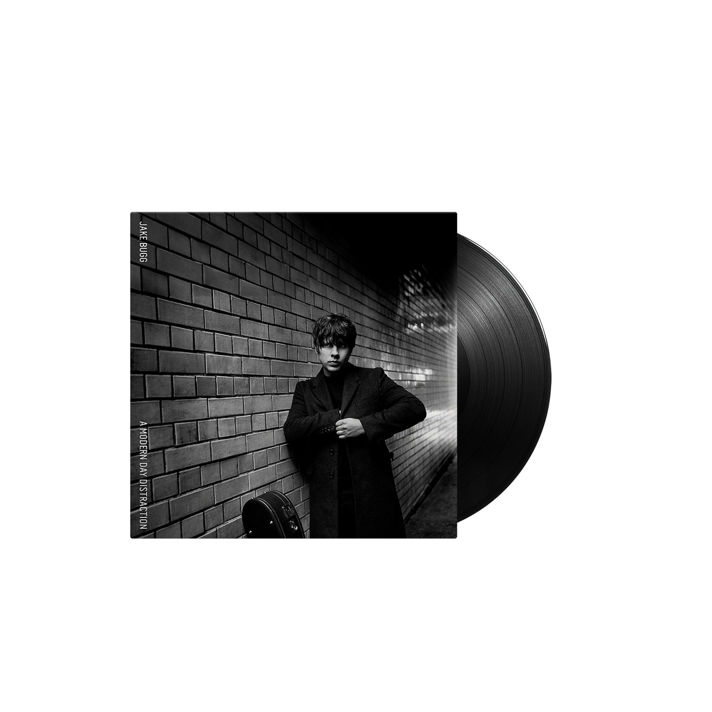 Jake Bugg standing against a brick wall next to a vinyl record.
