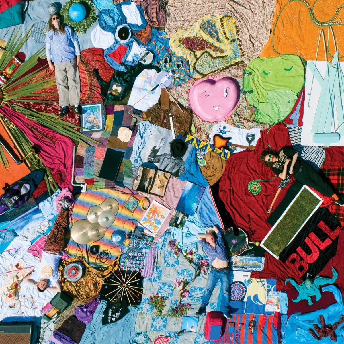 Album cover for Bull's "Discover Effortless Living" with people and objects.