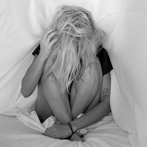Black and white photo of a person with messy hair, seemingly distressed.