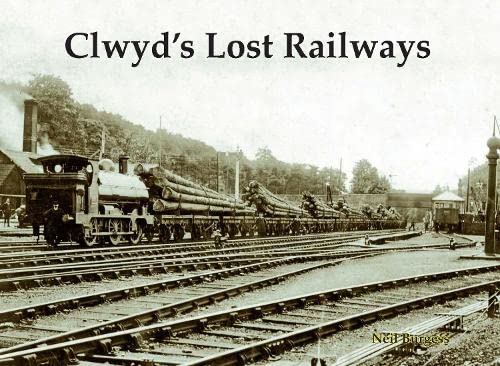 Vintage photograph of a steam train hauling timber on railway tracks.