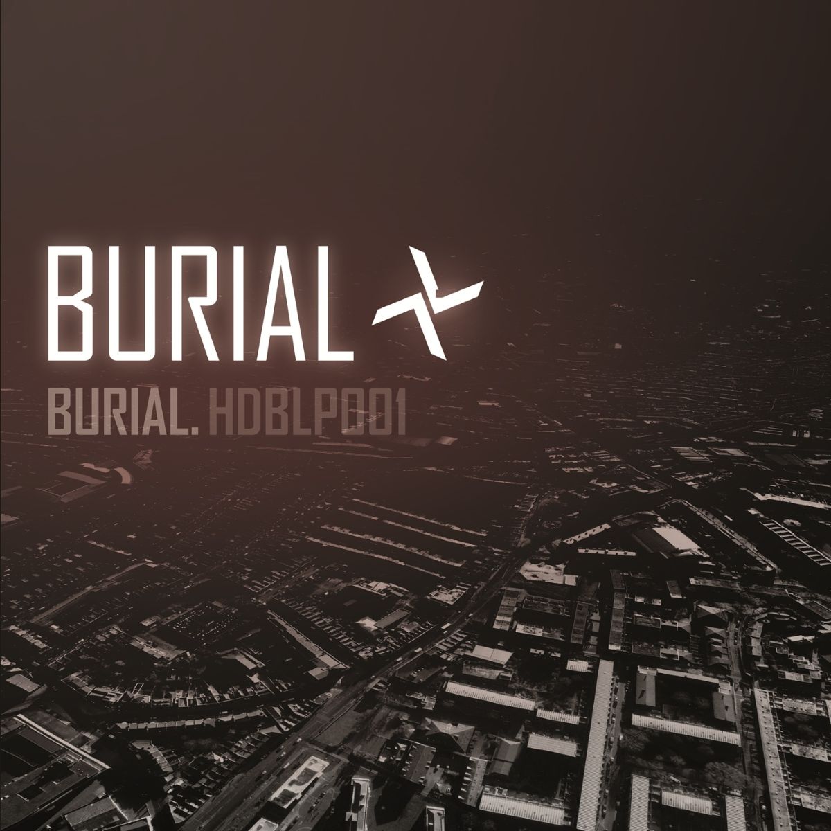 Burial album cover with white text over a dark cityscape.