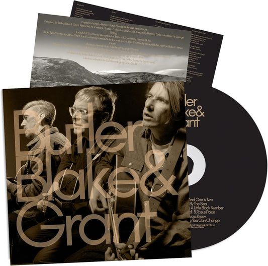 CD case featuring three musicians against a stormy seascape, with white text.