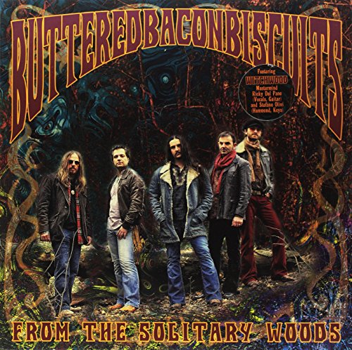 Album cover: band portrait with forest background and bold title text.