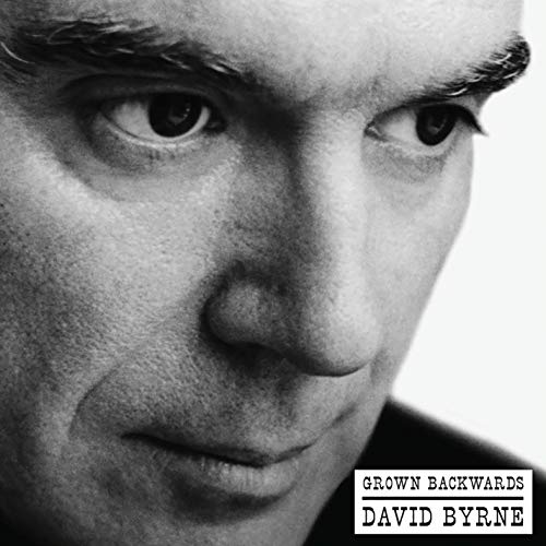 A black and white close-up of David Byrne's face with album title text.