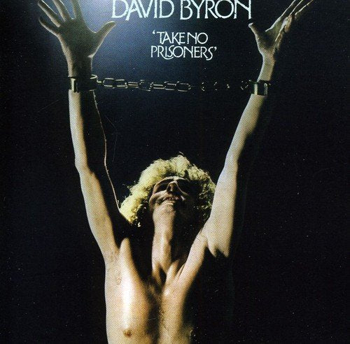 "Album cover with man chained by wrists, arms raised, against a dark background."