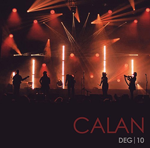 Calan band performing on stage with dramatic orange and yellow lighting.