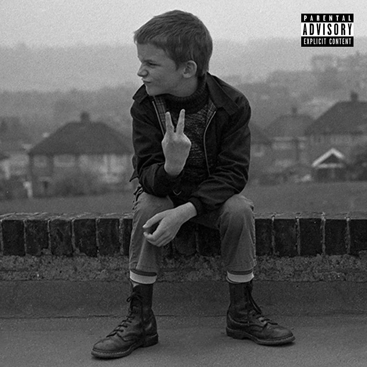 "Black and white album cover featuring a young boy making a peace sign."