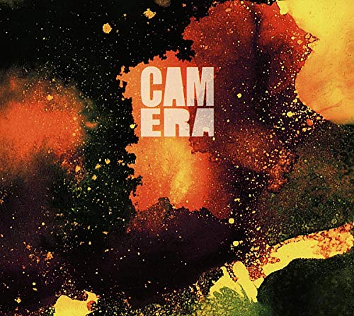 The image shows an abstract album cover with the text "CAMERA" in white letters. For accessibility purposes, a suitable alt text could be: "Album cover with 'CAMERA' text on abstract orange, yellow, and black background."