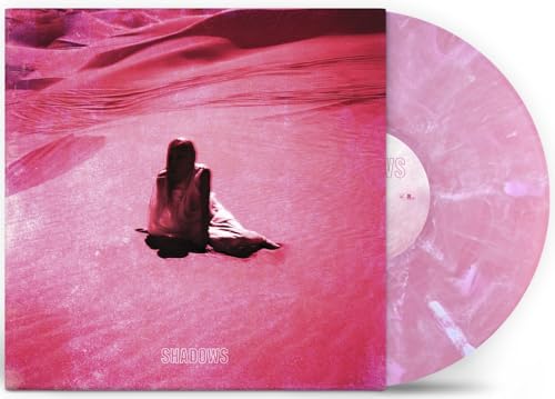 Vinyl record with pink swirl pattern, album cover shows a lone figure.