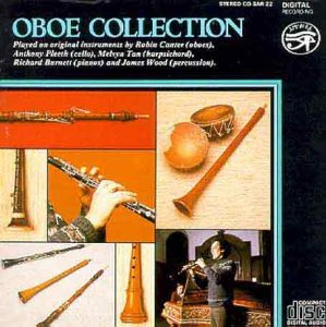 "CD cover with images of oboes and a musician playing, on a black background."