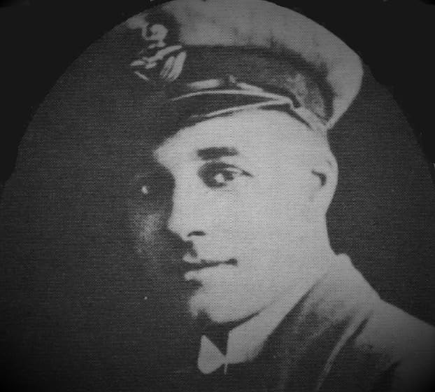 Black and white portrait of a man in a pilot’s cap.