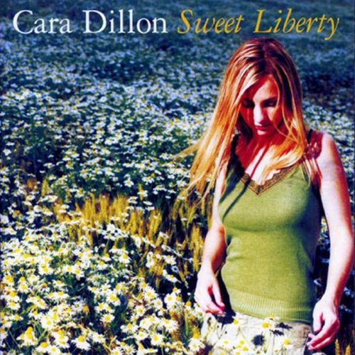 Album cover: blonde woman in a green top standing in a field of daisies.