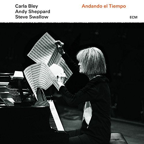 Woman at piano holding sheet music, album cover for "Andando el Tiempo".