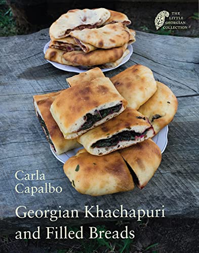 Stack of golden Georgian khachapuri and filled breads on plates.