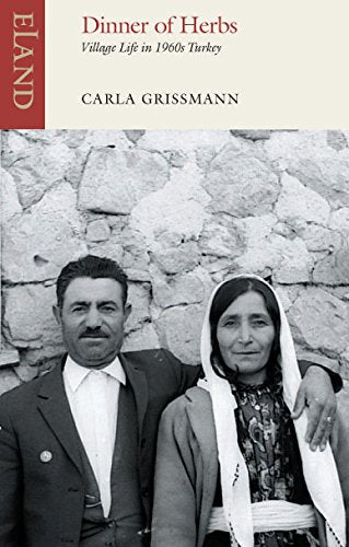 Black and white portrait of a couple in front of a stone wall.