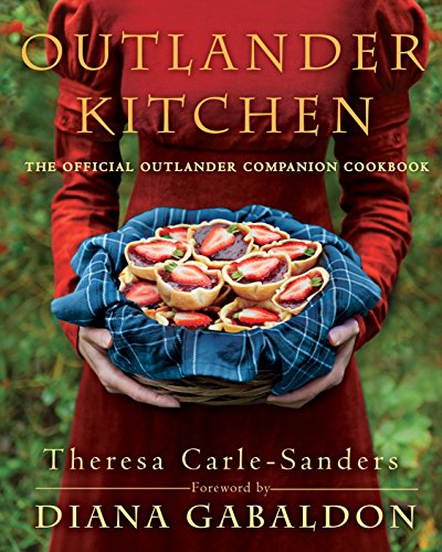 Cookbook cover featuring a woman holding a basket of strawberry tarts.