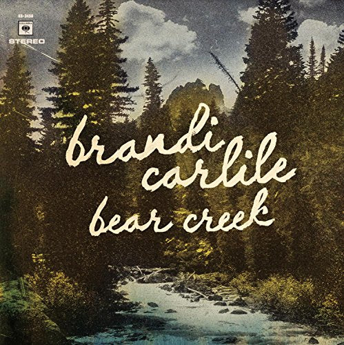 Album cover featuring a forest landscape with a creek and cursive white text.