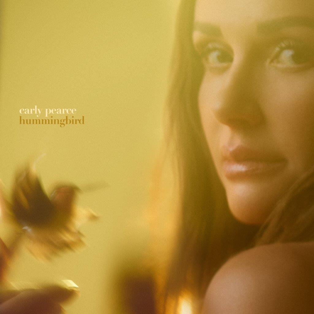 Carly Pearce album cover featuring a close-up of her face with a soft yellow glow.