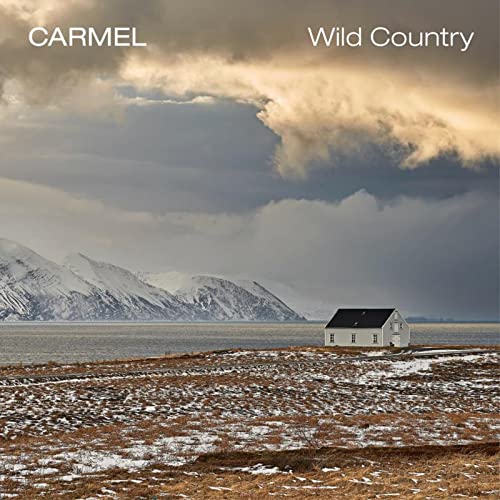 Album cover showing a white house by a snowy landscape with mountains and clouds.