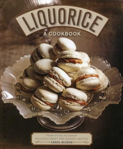 Cookbook cover featuring a stack of liquorice macarons on a silver dish.
