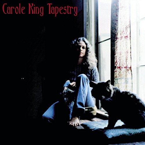 Carole King sits by a window with a cat, album cover art.