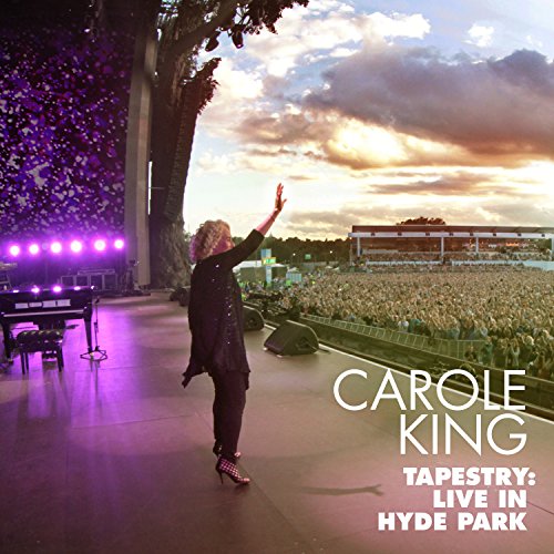 Carole King performing on stage at Hyde Park, with a large crowd.