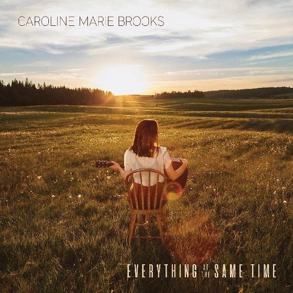 CD cover: woman with guitar sits in field at sunset.