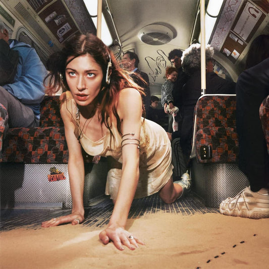 Woman in a slip crawling on a crowded subway floor.
