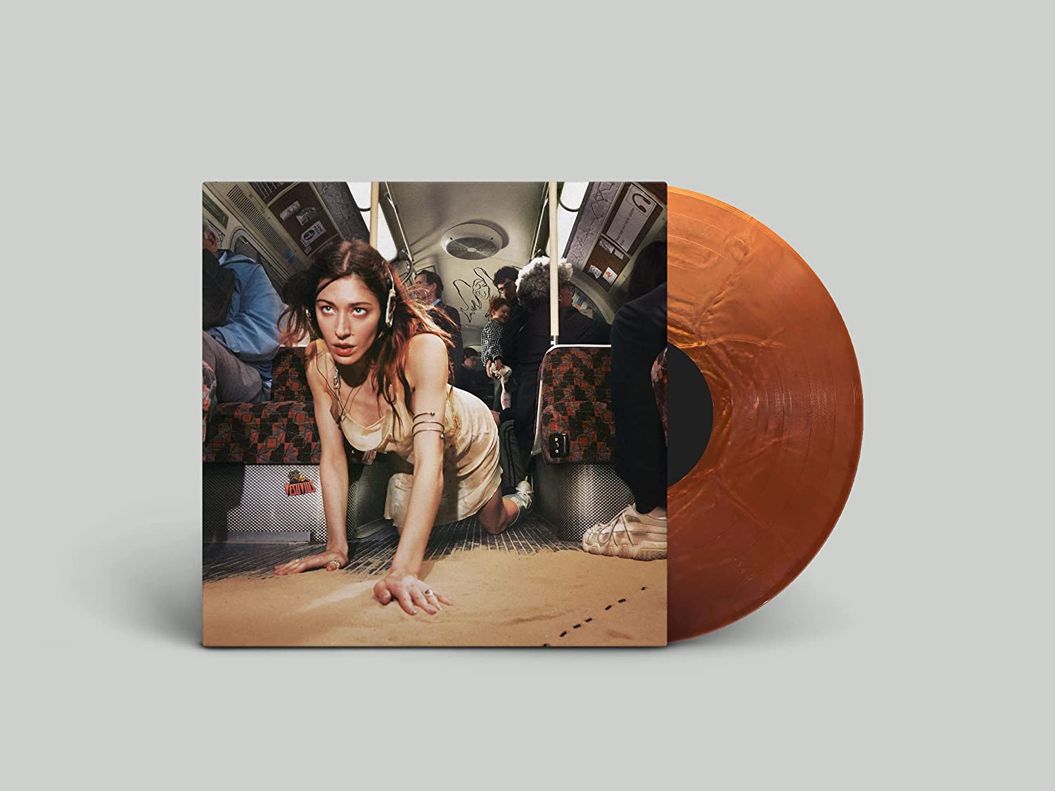 "Vinyl record with orange disc and album cover featuring a woman on a subway."